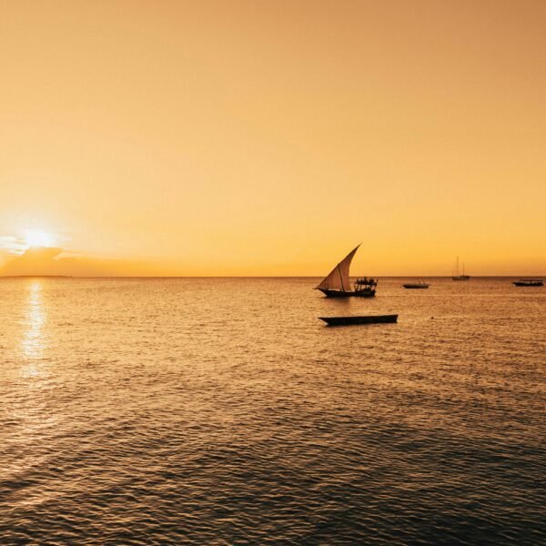 Dramatic sunset with dhow boat silhouette in Zanzibar